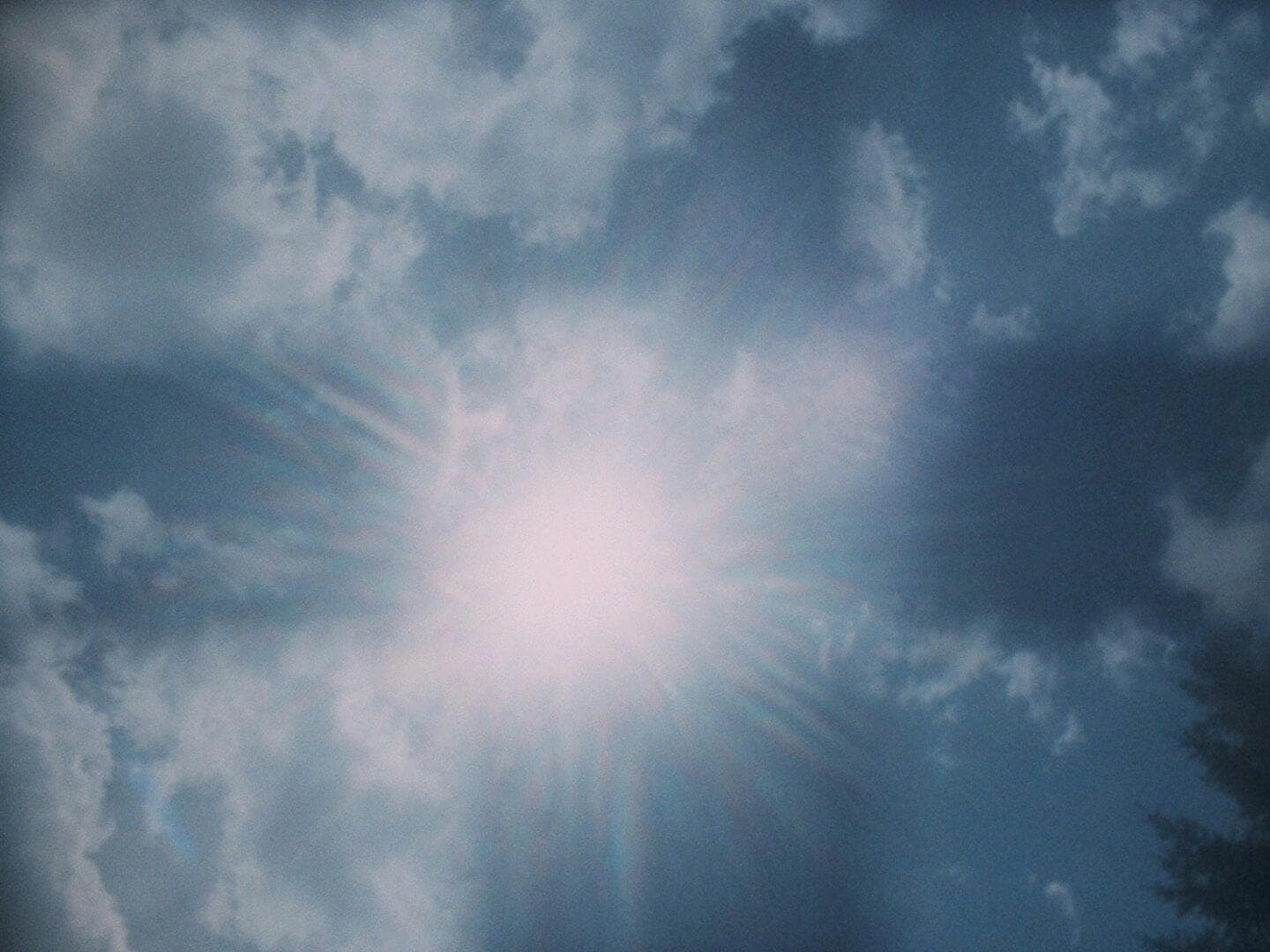 Clouds appar in a 3x3 checkerboard pattern; a lens flare blows through the center square
