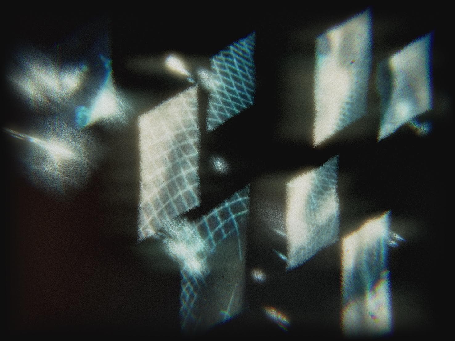 Angled panels of projected light floating in darkness, their surfaces crossed by pale blue grid and lattice patterns