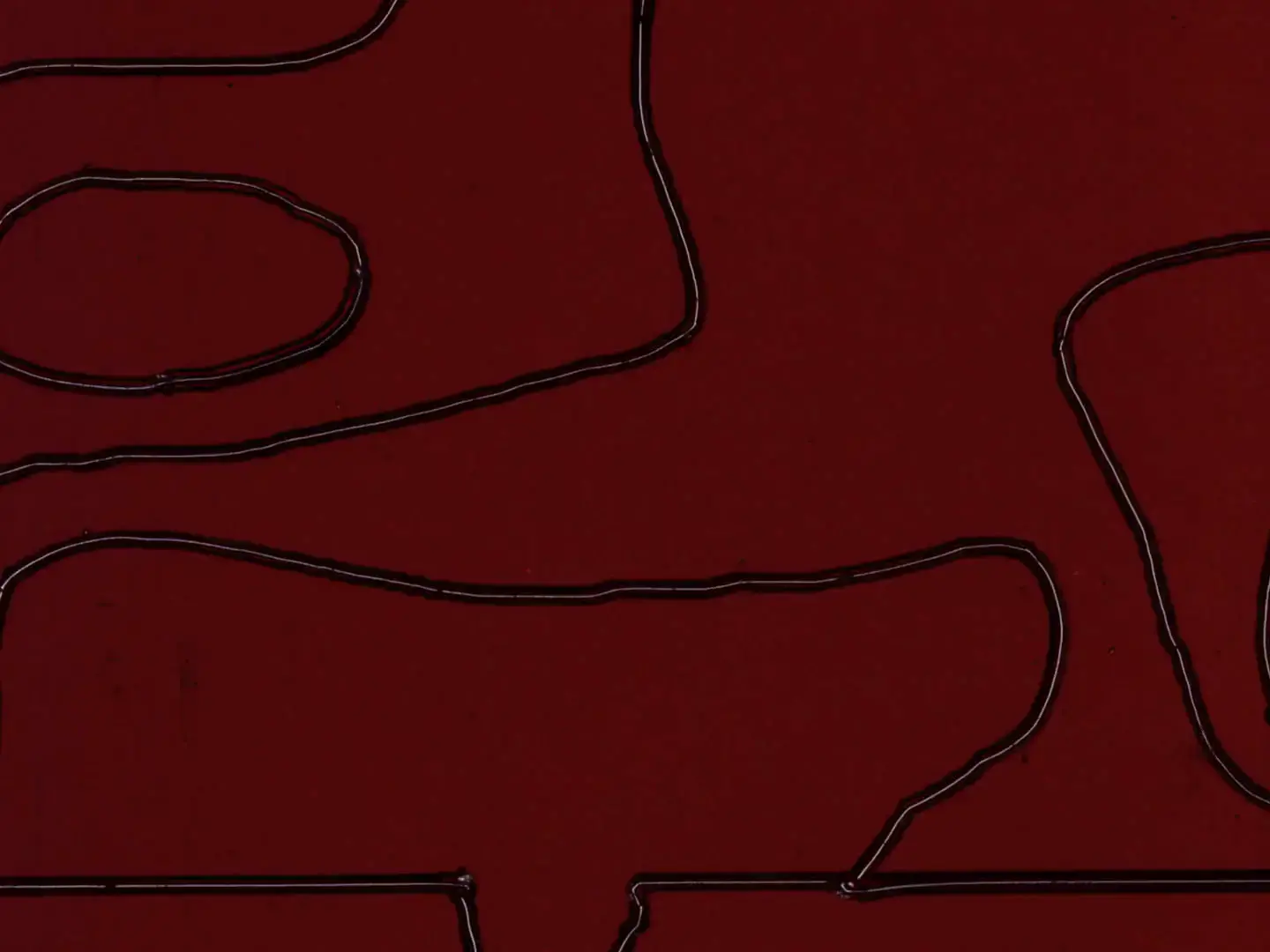 Abstract geometric lines etched into deep crimson Ektachrome film frame with angular pathways creating maze-like patterns