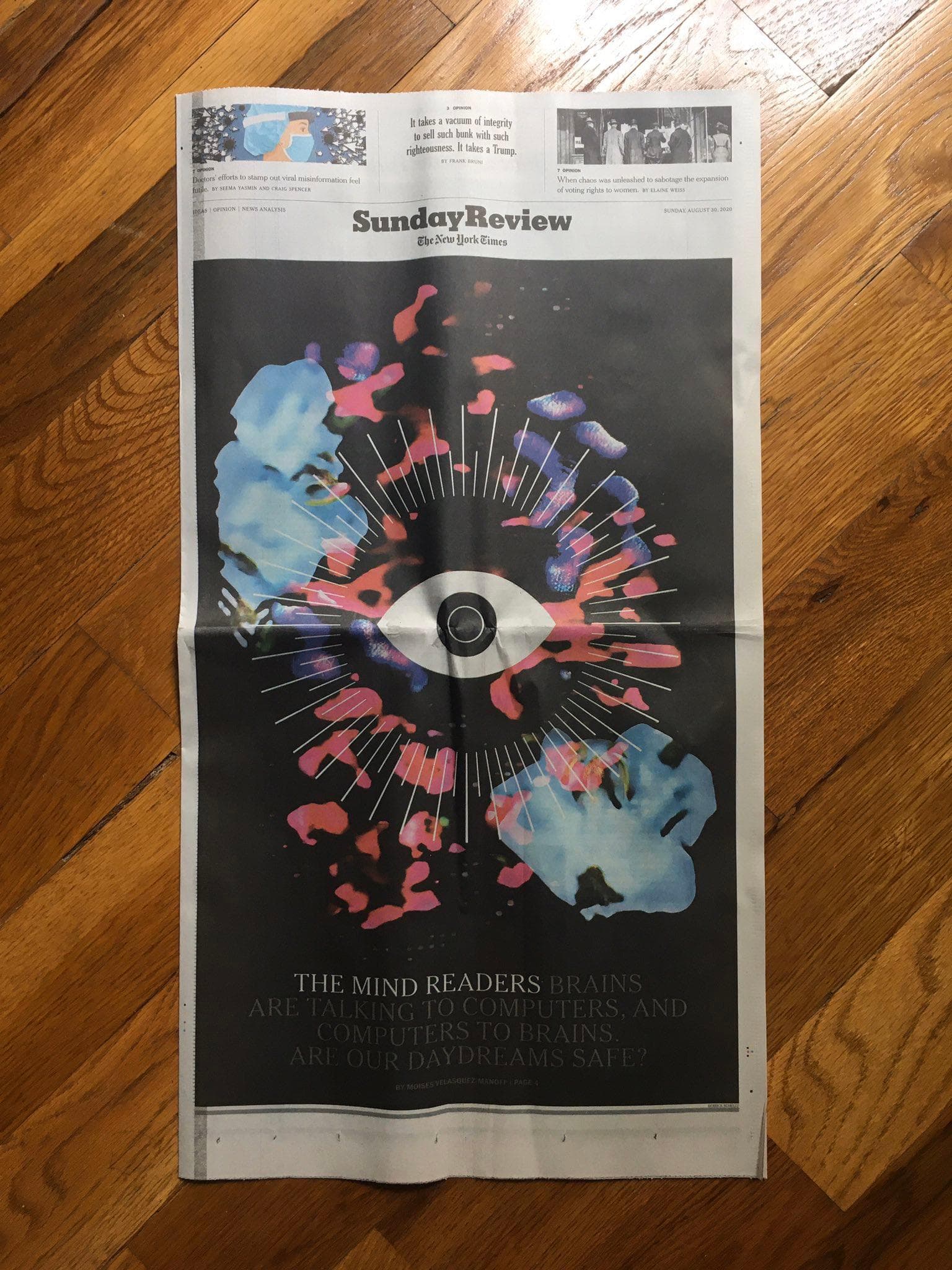 Image of newspaper cover front with abstract flowers and graphic eye